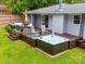 Outdoor deck with a hot tub, seating, and a well-maintained lawn at 4024 Seaforth Dr, Charlotte, NC 28205