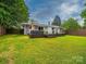 Backyard featuring a deck with hot tub, lounge furniture and a large grassy area at 4024 Seaforth Dr, Charlotte, NC 28205