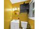 Bathroom with a mirrored vanity and a retro mustard yellow color scheme at 4024 Seaforth Dr, Charlotte, NC 28205
