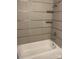 Clean bathroom featuring tile walls and a sleek white bathtub with a chrome faucet at 4024 Seaforth Dr, Charlotte, NC 28205