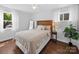 Cozy bedroom with a decorative headboard, soft bedding, and bright windows at 4024 Seaforth Dr, Charlotte, NC 28205