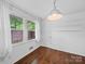 Bright bedroom with wood floors, natural light, and white paneled walls at 4024 Seaforth Dr, Charlotte, NC 28205