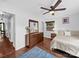 Bright bedroom with hardwood floors, ceiling fan, and a large dresser with a stylish mirror at 4024 Seaforth Dr, Charlotte, NC 28205