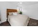 Cozy bedroom with a decorative headboard, soft bedding, and bright windows at 4024 Seaforth Dr, Charlotte, NC 28205