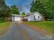 Charming single-story home with a gray brick exterior, a yellow front door, and a well-manicured lawn at 4024 Seaforth Dr, Charlotte, NC 28205