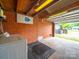 A utilitarian garage with a red brick wall, laundry appliances, and ample open space at 4024 Seaforth Dr, Charlotte, NC 28205
