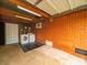 A utilitarian garage with exposed brick wall, laundry appliances, and concrete floor at 4024 Seaforth Dr, Charlotte, NC 28205