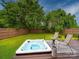 Backyard with a hot tub on a wooden deck and a grassy yard with a wood fence at 4024 Seaforth Dr, Charlotte, NC 28205