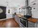Charming kitchen with stainless steel appliances, butcher block countertops, and white paneled walls at 4024 Seaforth Dr, Charlotte, NC 28205