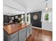 Open kitchen flows into the living room, featuring wood countertops and gray cabinets at 4024 Seaforth Dr, Charlotte, NC 28205