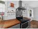 Close up on Kitchen featuring stainless steel appliances, wood countertops, and white cabinets at 4024 Seaforth Dr, Charlotte, NC 28205