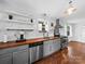 Bright kitchen with wood countertops, stainless steel appliances, and white cabinets at 4024 Seaforth Dr, Charlotte, NC 28205
