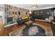 Comfortable living room with eclectic wallpaper, hardwood floors, a leather sofa, and stylish furnishings at 4024 Seaforth Dr, Charlotte, NC 28205