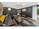 Stylish living room featuring a black leather sofa, hardwood floors, fireplace, and unique decor at 4024 Seaforth Dr, Charlotte, NC 28205