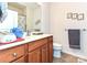 Cozy bathroom with wood cabinets, a mirror, and framed artwork on the wall at 44429 Oriole Dr # 102, Indian Land, SC 29707