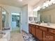 Bathroom with double sinks, a walk-in shower, and a door leading to a walk-in closet at 44429 Oriole Dr # 102, Indian Land, SC 29707