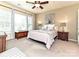Inviting bedroom featuring a ceiling fan, bedside tables, and a sun-filled window at 44429 Oriole Dr # 102, Indian Land, SC 29707