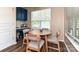 Cozy breakfast nook with blue cabinets, table, and natural light from window at 44429 Oriole Dr # 102, Indian Land, SC 29707
