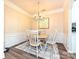 Traditional dining room with wainscoting, chandelier, and wood table for four at 44429 Oriole Dr # 102, Indian Land, SC 29707