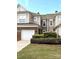 Charming townhome with a one-car garage and brick accents, surrounded by lush landscaping at 44429 Oriole Dr # 102, Indian Land, SC 29707