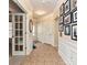 Elegant foyer with tiled floors, decorative lighting, and a gallery wall of framed photos at 44429 Oriole Dr # 102, Indian Land, SC 29707