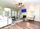 Bright living room featuring hardwood floors, fireplace, and ceiling fan at 44429 Oriole Dr # 102, Indian Land, SC 29707