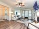 Cozy living room with hardwood floors, a ceiling fan, and large windows for natural light at 44429 Oriole Dr # 102, Indian Land, SC 29707