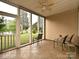 Enclosed patio with tile flooring and screens, offering views of the pond at 44429 Oriole Dr # 102, Indian Land, SC 29707