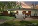 Backyard featuring a brick house, artificial turf, and string lights perfect for outdoor enjoyment at 4626 Fairbluff Pl, Charlotte, NC 28209