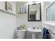 Bright bathroom with beadboard paneling, a pedestal sink, and a decorative mirror at 4626 Fairbluff Pl, Charlotte, NC 28209