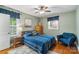 Charming bedroom with a cozy blue armchair and a window with natural light at 4626 Fairbluff Pl, Charlotte, NC 28209