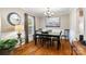 Cozy dining room with hardwood floors and a charming chandelier above the table at 4626 Fairbluff Pl, Charlotte, NC 28209