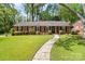 Charming brick home with a manicured front yard, walkway and mature trees at 4626 Fairbluff Pl, Charlotte, NC 28209