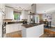 Well-lit kitchen with white cabinets, stainless steel appliances, and a functional center island at 4626 Fairbluff Pl, Charlotte, NC 28209
