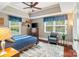 Comfortable main bedroom features a tray ceiling, natural light, and a cozy sitting area at 4626 Fairbluff Pl, Charlotte, NC 28209