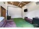 Shed interior featuring a projector screen, air conditioning, and finished walls at 4626 Fairbluff Pl, Charlotte, NC 28209
