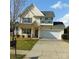 Charming two-story home boasts a well-manicured lawn, a spacious driveway, and an attached two-car garage at 464 Laurel Fork Dr, Fort Mill, SC 29715