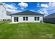 The backyard with a new roof, sliding glass doors, and lush green lawn at 540 Church St, Locust, NC 28097