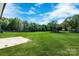 Expansive backyard featuring lush green grass and mature trees at 540 Church St, Locust, NC 28097