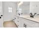 Modern bathroom features a double sink vanity with granite countertop, black hardware, and luxury vinyl flooring at 540 Church St, Locust, NC 28097