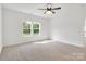 Bright bedroom featuring two windows that let in natural light, neutral carpet, and freshly painted walls at 540 Church St, Locust, NC 28097
