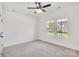 Neutral bedroom featuring two windows offering natural light, with a ceiling fan and neutral carpet at 540 Church St, Locust, NC 28097