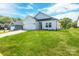 Attractive single-Gathering home featuring green grass, and an attached two-car garage with a concrete driveway at 540 Church St, Locust, NC 28097