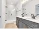 Modern bathroom features double vanity, sleek fixtures, and glass-enclosed shower with white marble tiling at 544 Church St, Locust, NC 28097