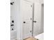 Bathroom featuring combination shower and tub with white door and matte black fixtures at 544 Church St, Locust, NC 28097