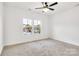 Bright bedroom with two windows offers natural light and neutral carpet, blank space for decorating at 544 Church St, Locust, NC 28097