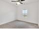 Cozy bedroom with neutral carpet, ceiling fan, and a bright window at 544 Church St, Locust, NC 28097