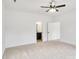 Bright bedroom with ceiling fan, neutral carpet, and open bathroom entry, offering ample space at 544 Church St, Locust, NC 28097