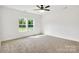 Sunlit bedroom with verdant views from double windows, paired with neutral carpet and ample space at 544 Church St, Locust, NC 28097