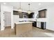 Modern kitchen with a center island, stainless steel appliances, and black cabinetry at 544 Church St, Locust, NC 28097